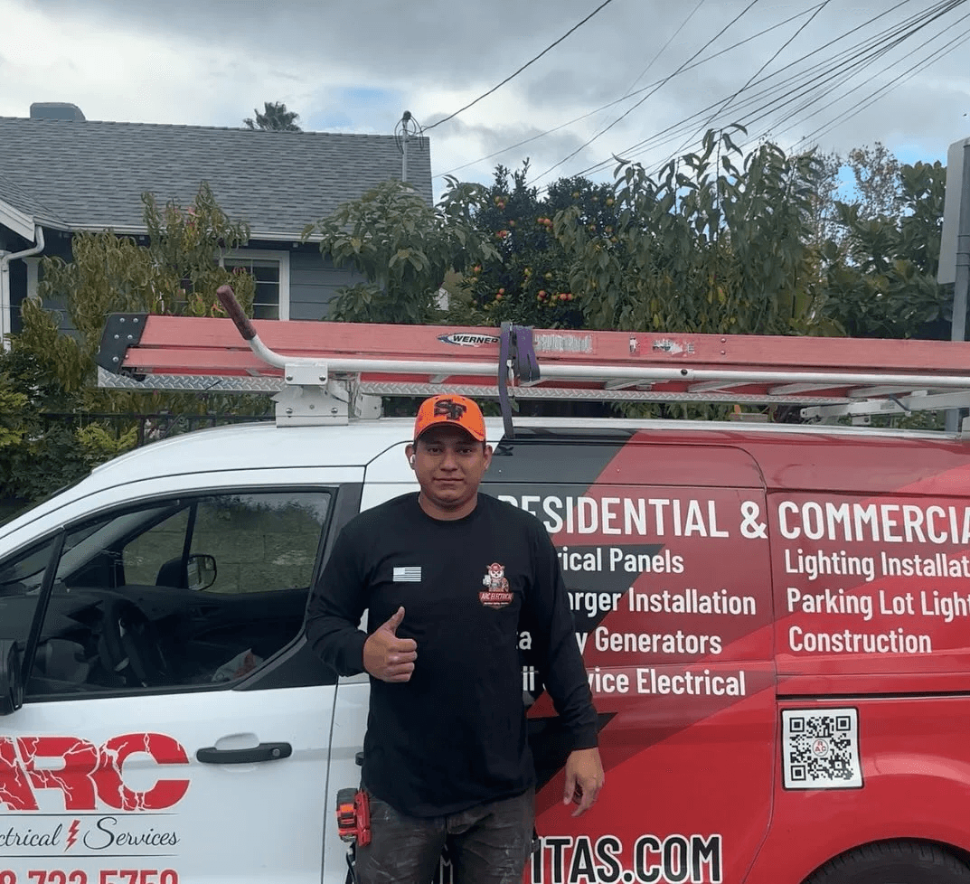 ARC Electric technician in front of a service van